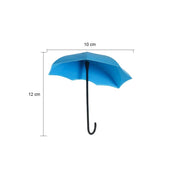 Side view of an umbrella key holder demonstrating its adhesive backing.