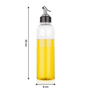 Hand pouring oil from the 1 litre transparent plastic oil dispenser with precise control.