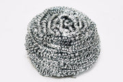 Round stainless steel scrubber showing its intricate wire design for superior scrubbing.