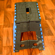 A person standing confidently on the 18-inch plastic step stool to reach a top kitchen cabinet.